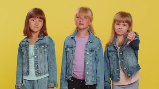 十代の少女は,サインジェスチャーを示し,不満,不満,不満,嫌悪を表しています. 小さな子供たち。 スタジオ黄色の背景に隔離された3人の兄弟の子供 - 映像、動画