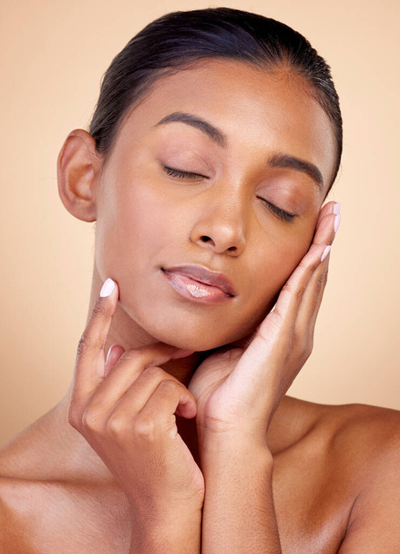 Relax, skincare or Indian woman with natural beauty or facial glow with dermatology cosmetics in studio. Eyes closed, wellness or face of calm girl model resting or sleeping with makeup or self love. - Fotó, kép