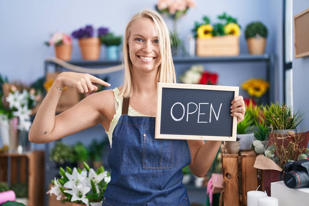 Young caucasian woman working at florist with open sign pointing finger to one self smiling happy and proud  - Photo, Image