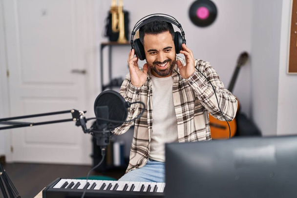 Young hispanic man artist singing song at music studio - Zdjęcie, obraz