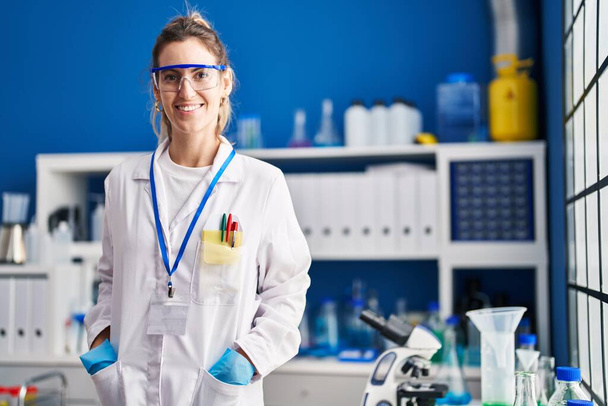 Young woman scientist smiling confident standing at laboratory - Zdjęcie, obraz