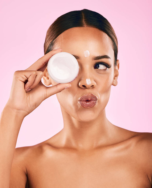 Beauty, cream and portrait of woman with skincare and cosmetics for facial care, dermatology or treatment on pink background. Face, happy and healthy girl with product, lotion or moisturizer on skin. - Фото, изображение