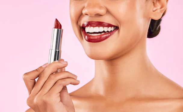 Lipstick, red lips and woman with smile, beauty and skin with makeup closeup isolated on pink background. Female model, cosmetic product and shine, happiness and cosmetology with glow in studio. - Photo, Image