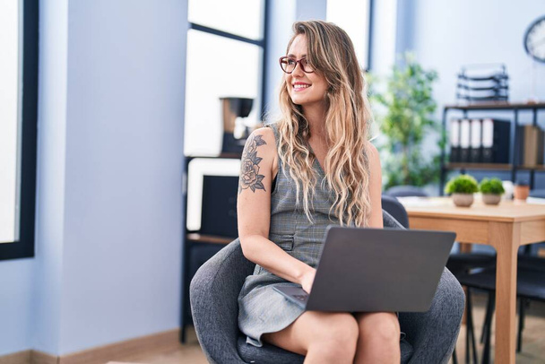Молодая женщина бизнес-работник с помощью ноутбука в офисе - Фото, изображение