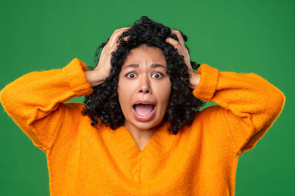 Stress. Dark-haired woman in orange looking stressed and shocked - Фото, зображення