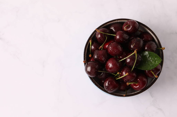bowl of tasty fresh cherries on white marble background. high quality photo - Photo, image