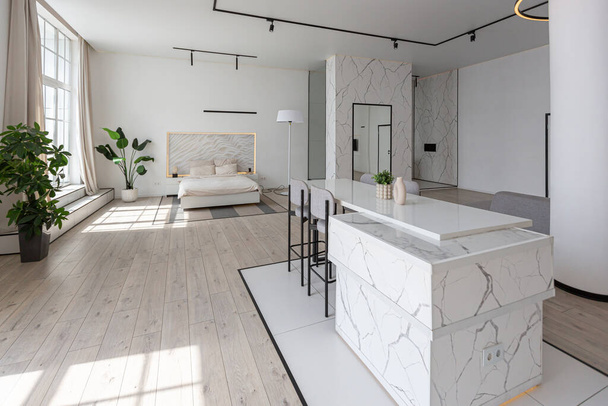minimalistic modern luxury design of an expensive house with marble trim on a sunny day. white walls with plaster, parquet, decorative lighting and no one inside - 写真・画像
