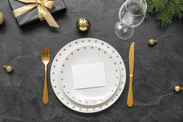 Beautiful table setting for Christmas celebration on black background - Foto, immagini