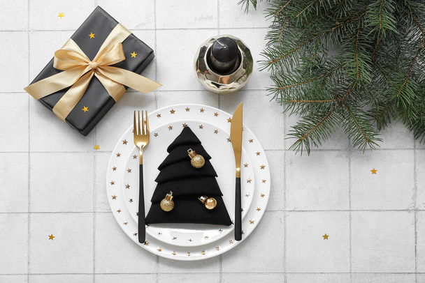 Beautiful table setting for Christmas celebration on white tile background - Photo, Image