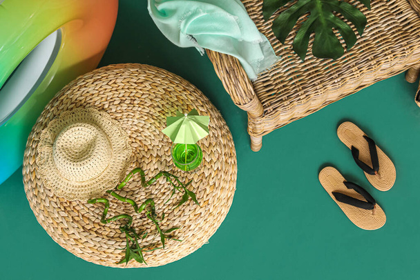 Beach accessories, glass of cocktail and bamboo branches on color background - Φωτογραφία, εικόνα