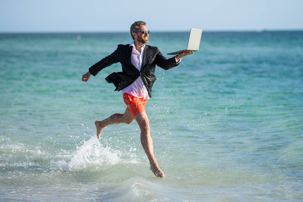 summer inspiration for business man. Beach for the director businessman. Businessman director running at beach. director is very ambitious and carefree businessman. Seashore business opportunities. - Photo, Image