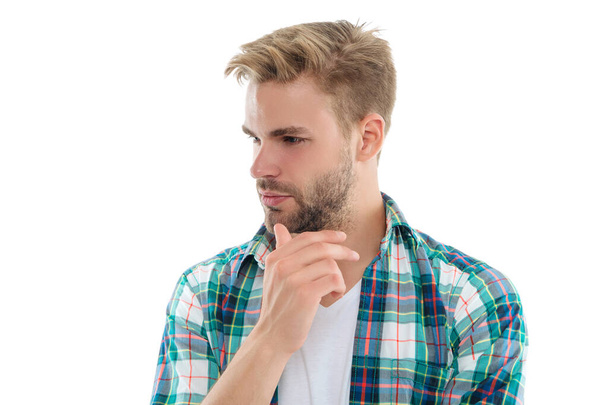 thinking millennial man in studio. photo of millennial man wearing checkered shirt. millennial man isolated on white. millennial man on background. - Фото, зображення