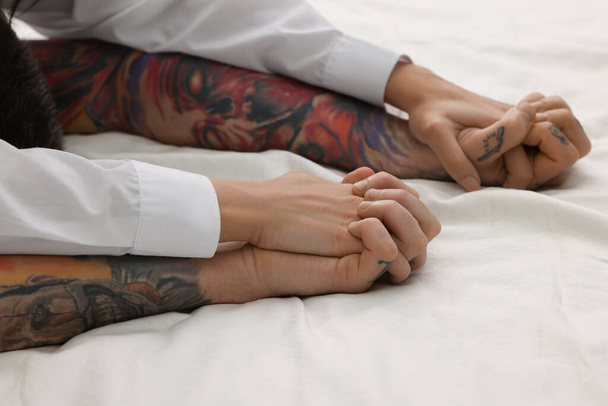 Passionate couple having sex on bed, closeup of hands - Photo, Image