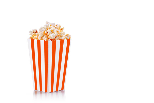 cardboard glass orange, brown with popcorn on a white transparent background close-up - Zdjęcie, obraz