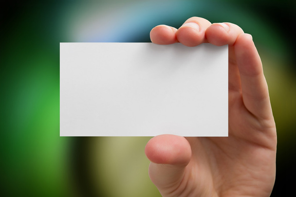 背景をぼかした写真の白のビジネス カードを持っている手 - 写真・画像
