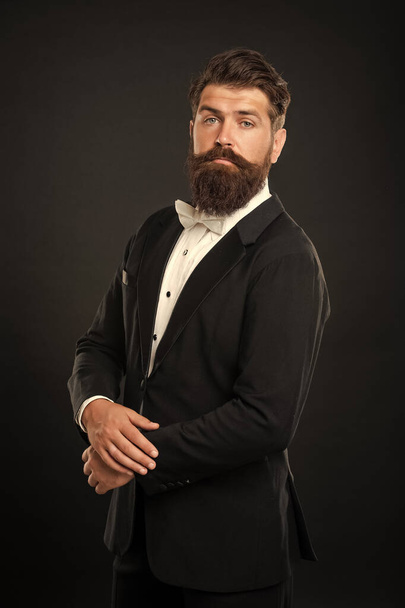 bearded bridegroom in tuxedo on black background, groomsman. - Fotografie, Obrázek