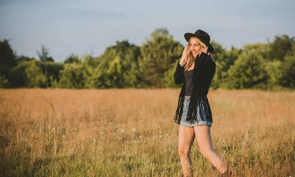 Sexy Girl in American country style, suede leather boho jacket and shorts, cowgirl style at nature - Photo, image