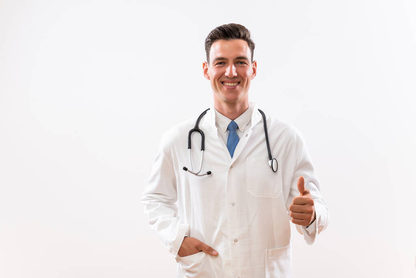 Portrait of young  content doctor showing thumb up. - Photo, Image