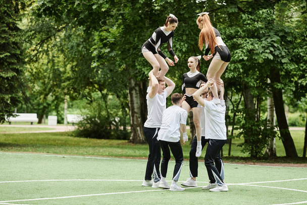 Cheerleading team doing tricks at performance outdoors - Foto, Imagen