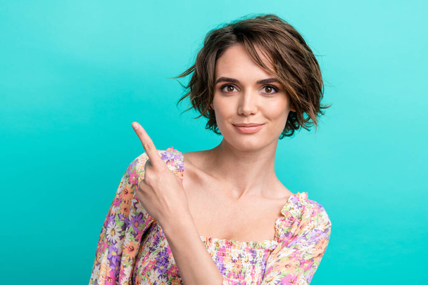 Portrait of gorgeous positive person indicate finger empty space offer isolated on turquoise color background. - Foto, afbeelding