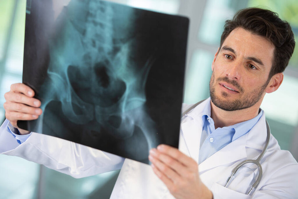 doctor man looking at x-ray radiography - Photo, Image