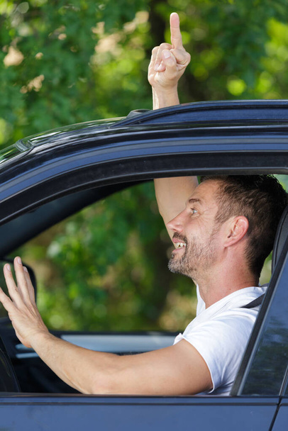 man in the car showing a middle-finger - Photo, image
