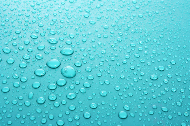Голубые капли воды на фоне больших и малых капель
 - Фото, изображение