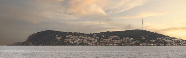 Вид на горы острова Киналиада с Мраморного моря, с традиционными летними домиками и лодками, Стамбул, Турция - Фото, изображение