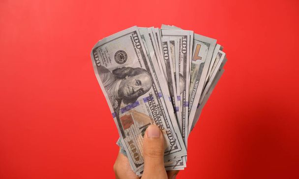 Hundred dollar bills on red background, Banknotes for money saving, Cash money dollars, Business investment and income, Global financial crisis, Earning and saving money concept. High quality photo - 写真・画像