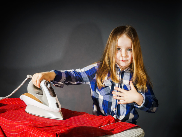 Cute little girl helping your mother by ironing clothes, contras - Фото, зображення