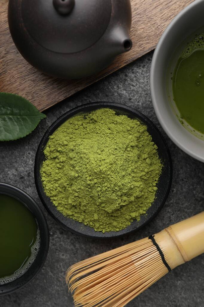 Flat lay composition with green matcha powder on grey table - 写真・画像