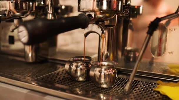 Espresso in a white cup. Caffeine. Flowing fresh ground coffee. Espresso machine making fresh coffee. Pouring coffee stream from machine in cup. Drinking roasted black coffee. - Filmati, video