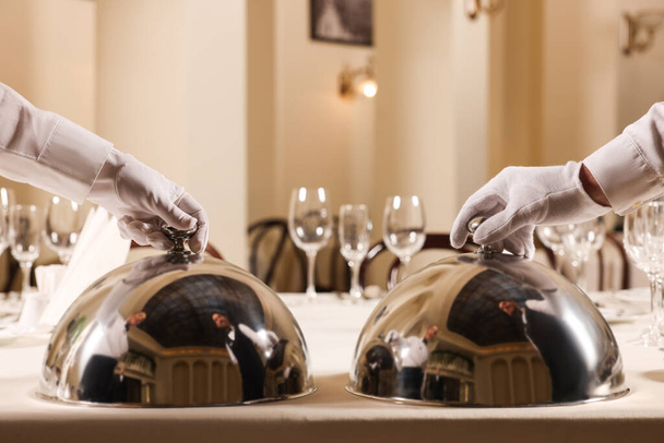 Men setting table in restaurant, closeup. Professional butler courses - Foto, afbeelding