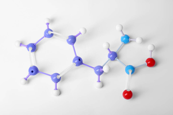 Molecule of phenylalanine on white background, top view. Chemical model - Photo, Image