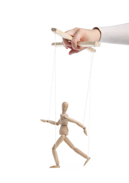 Woman pulling strings of puppet on white background, closeup - Foto, afbeelding