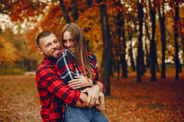 Couple in a park. Family in a golden forest. Man with a beard - Fotoğraf, Görsel