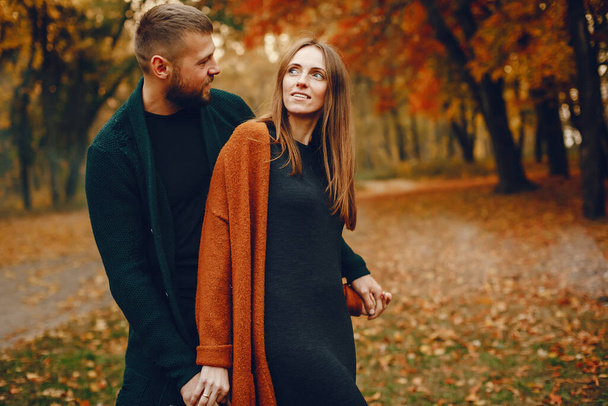 Couple in a park. Family in a golden forest. Man with a beard - Photo, Image