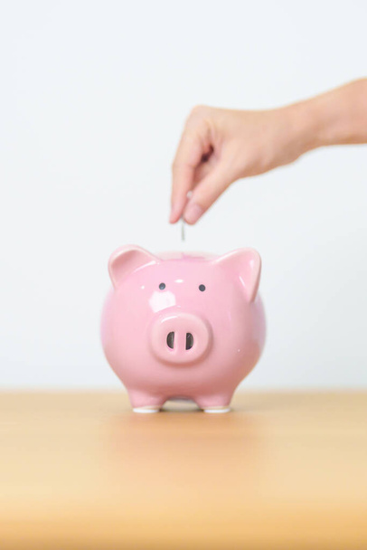 Money Saving for Future Plan, Retirement fund, Pension, Investment, Wealth Business and Financial concepts. hand holding and putting into piggy bank, Money Counting for World Savings day and Donate - Foto, imagen