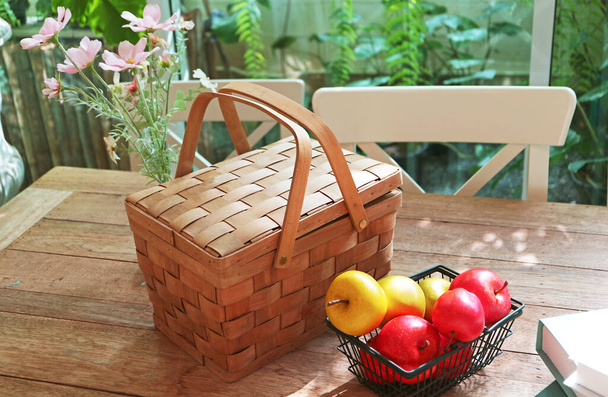Picnic basket with fruits and flowers ready for weekend outing - Fotó, kép