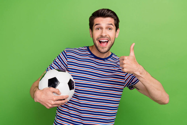 Photo of young guy excited funky football fan thumb up like sign professional real madrid player betting isolated on green color background. - Valokuva, kuva