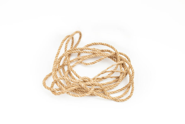Loose tangled jute rope coil, isolated on white background - Fotó, kép