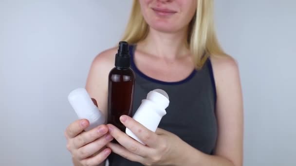 Girl holds in her hands three eco-friendly antiperspirants with natural ingredients. Refusal of antiperspirants containing toxic substances. Freedom from Aluminum chlorohydrate, alcohol, parabens - Video