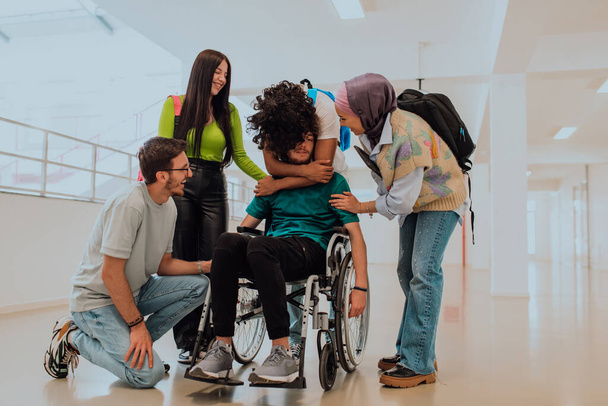 In a modern university, a diverse group of students, including an African American student and a hijab-wearing woman, walk together in the hallway, accompanied by their wheelchair-bound colleague. - Fotografie, Obrázek