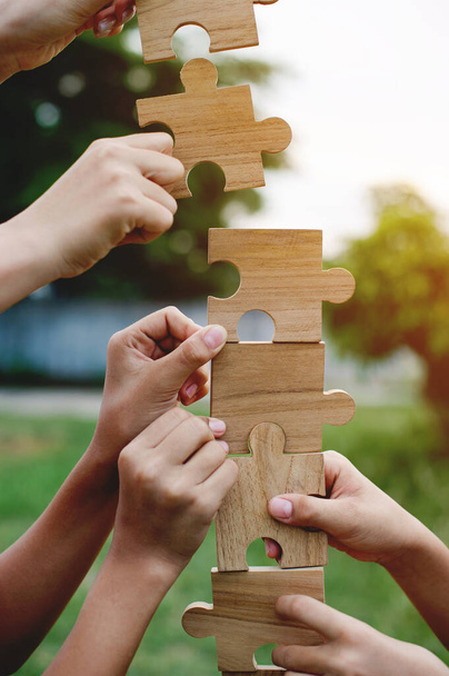 Jigsaw puzzle in hand, teamwork together communication puzzle piece teamwork concept - 写真・画像