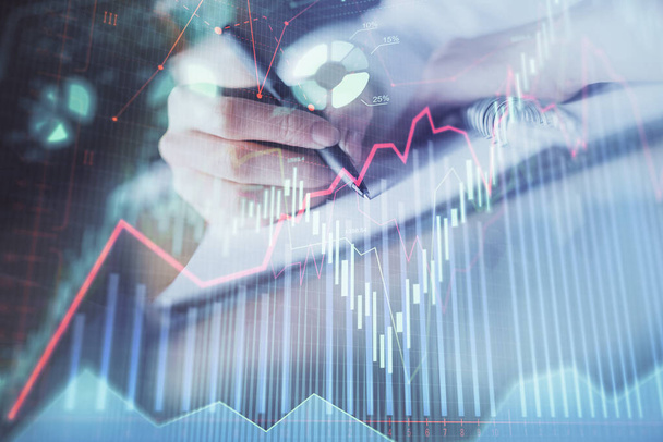 Financial forex graph displayed on hands taking notes background. Concept of research. Double exposure - Foto, imagen