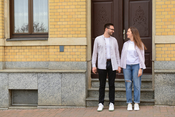 Beautiful loving happy couple walking in city on spring day - Foto, afbeelding