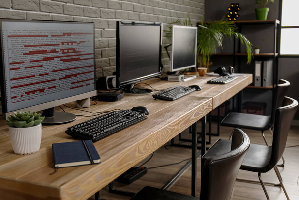 Programmer's workplaces with computer monitors in office - Foto, imagen