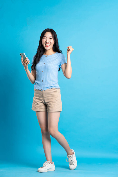 plné tělo obraz krásné asijské dívka pózovat na modrém pozadí - Fotografie, Obrázek
