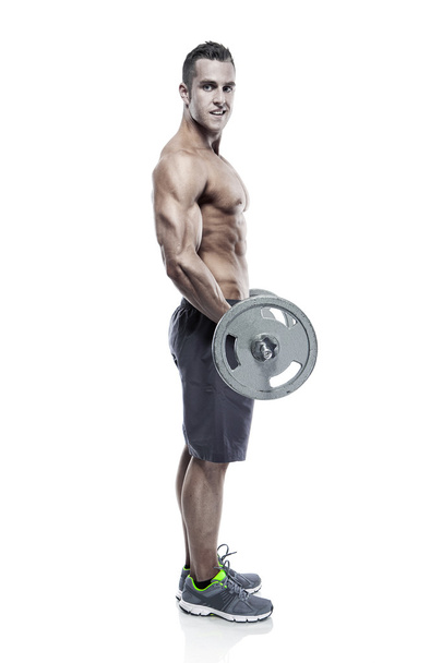 ボディービルダーの筋肉男大きなダンベルのエクササイズ  - 写真・画像