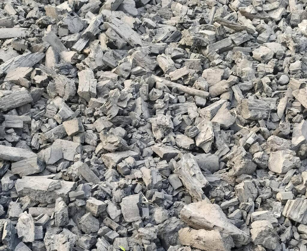 a photography of a pile of rubble with a yellow object in the middle, a close up of a pile of rocks and gravel with a yellow object in the middle. - Фото, зображення